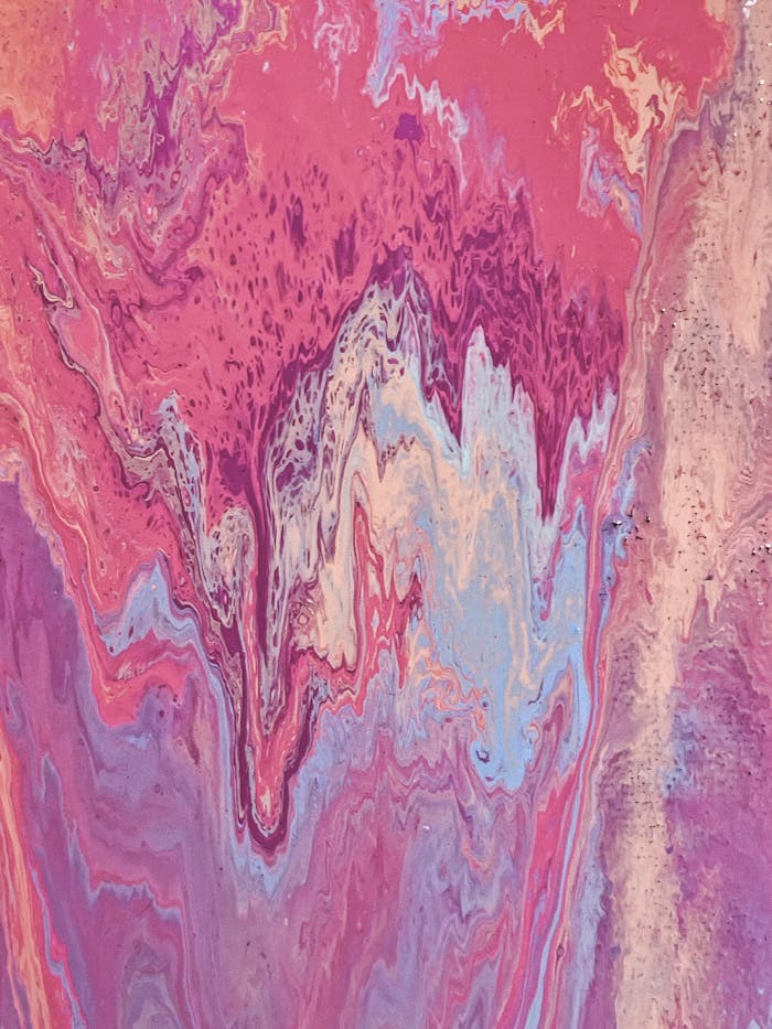 A vibrant and colorful abstract marbled paint pattern with swirling pinks and purples.
